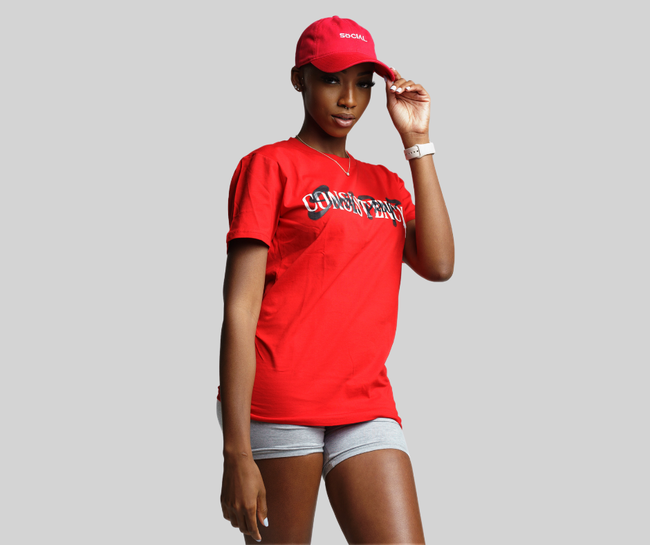 Woman wearing Consistency T-Shirt in Red with Red Social Proof hat